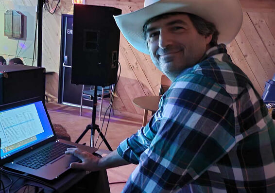 DJ Scribs in a cowboy hat behind his desk